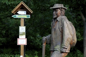 Wooden statue hiker with hat
