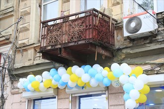 House facade in need of renovation with balloons in Panteleimonivska Street