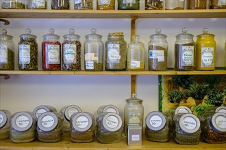 Spices and tea in glasses on shelf