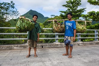 Local farmers bringing their goods in palm baskets back home