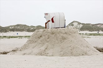 Beach chair on a built sand hill at the beach
