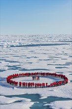 People forming a circle to memorise to have arrive on the North Pole