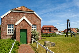 Old protestant island church with external church bell