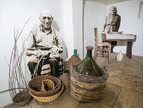 Farmer weaving a basket and farmer's wife at the dining table