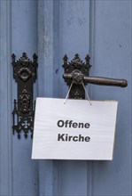 Open Church sign on the portal of the Protestant Church of St. Johannis in Luechow