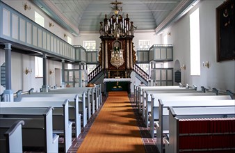 Interior with wooden barrel vault and pulpit altar of St. Nicholas Church