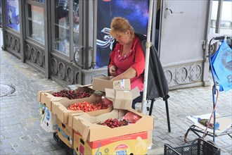 Vendor of cherries in front of Privoz food market
