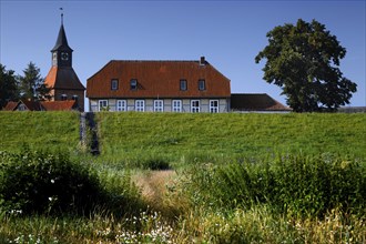 House and church behind the Elbe dyke