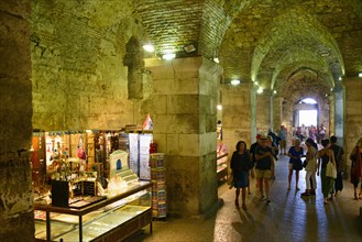 Merchants in illuminated catacombs