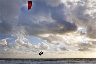 Kite surfer flying over the surf