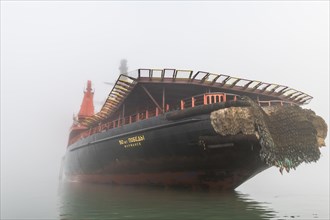 Icebreaker in the fog anchoring in Tikhaya bay on Hooker island