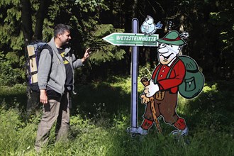 Hiker and sign Wetzsteinhuette