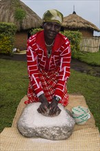 Woman preparing local bread at a ceremony of former poachers