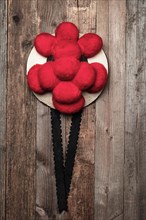 Original Black Forest Bollen hat in front of rustic wooden wall