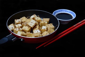 Fried tofu cubes in pan