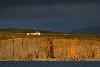 Farm and basalt cliff in the evening light