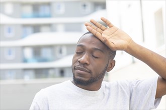 Young black man after fitness in the summer of the city