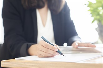 Woman signs contract with fountain pen