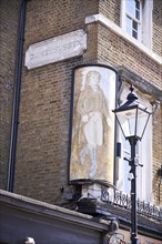 Duke of Sussex sign on yellow brick wall and old street lamp
