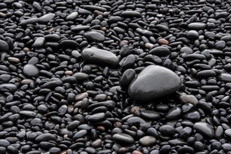 Black wet stones at Reynisfjara lava beach