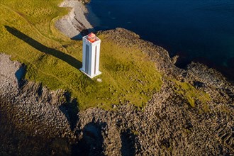 Lighthouse and coastal landscape with basalt formations