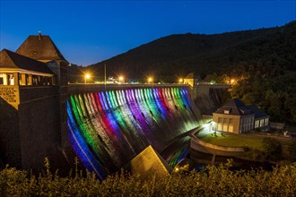 Illuminated dam wall in the evening twilight