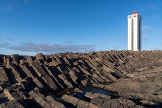 Lighthouse and coastal landscape with basalt formations