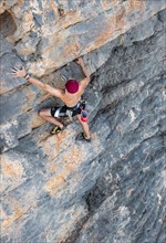 Climber climbing on a rock face