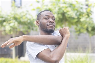 Young black man doing fitness in the summer of the city