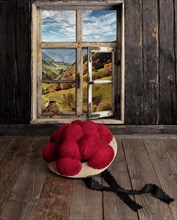 View through a window into the Muenstertal with Bollen hat on wooden table