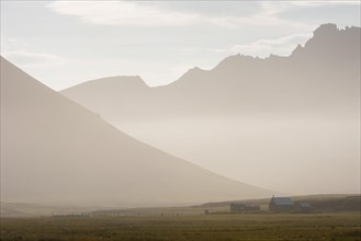 Cabins of the Icelandic Hiking Association in front of the mountain range Dyrfjoell