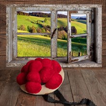 View through a window with Bollen hat on wooden table