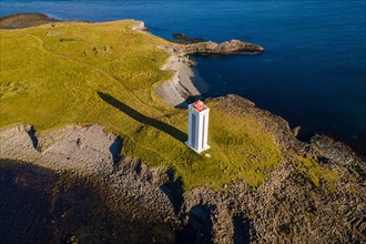 Lighthouse and coastal landscape with basalt formations