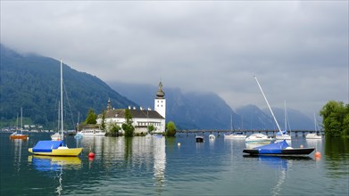 Orth Castle on Lake Traun in Gmunden and boats in the water