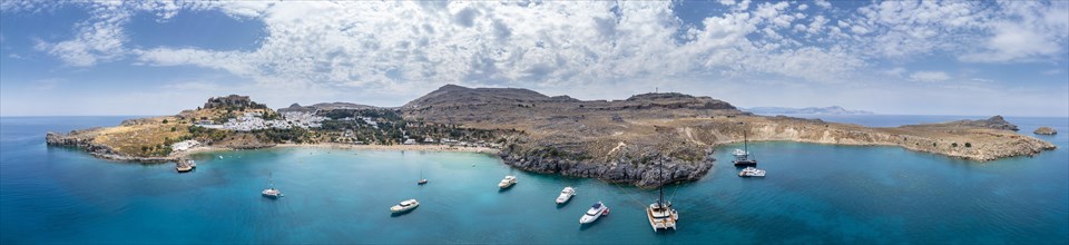 Sailboats anchoring in front of Lindos