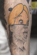Tattoo of a woman's head on a forearm