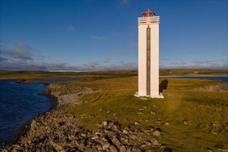 Lighthouse and coastal landscape with basalt formations