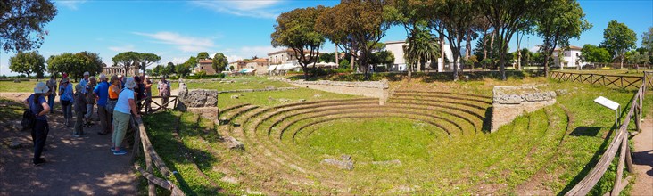 A tourist group visits the amphitheater of Paestum