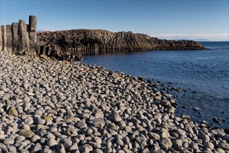 Basalt cliff and beach with rounded stones