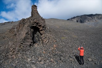 Tourist photographing volcanic vent at the table volcano Heroubreio or Herdubreid