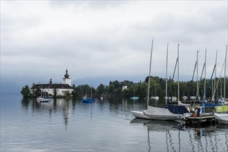 Orth Castle on Lake Traun in Gmunden and boats in the harbour