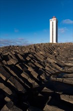 Lighthouse and coastal landscape with basalt formations