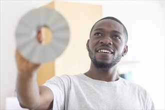 Young black man holding an idea as an invention