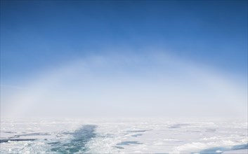 Fog bow or white rainbow in the ice around the North Pole