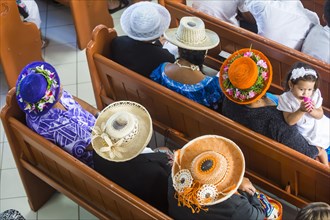 Women with traditional hats on a church service