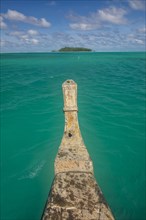 Traditional wood carved boat in the Aitutaki lagoon