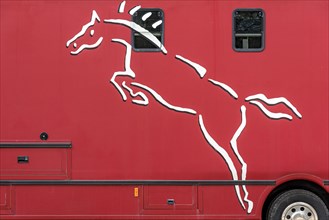 Logo of show horse on horse transporter