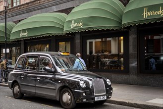 Black London Taxi outside the luxury department stores