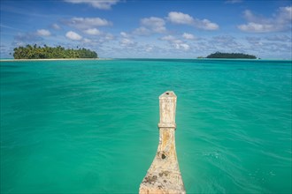 Traditional wood carved boat in the Aitutaki lagoon
