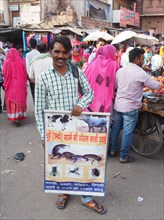 Street vendor presenting a poster